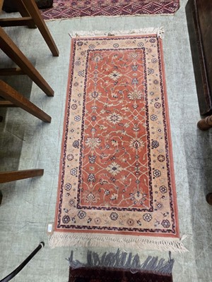 Lot 121 - An orange ground eastern rectangular wool rug...