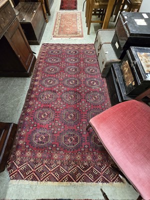 Lot 126 - A distressed eastern red ground hand woven...