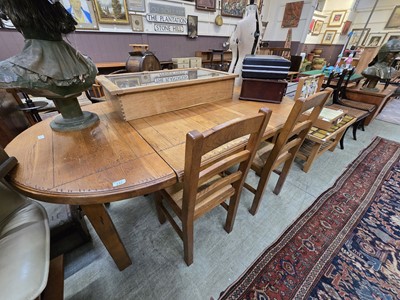 Lot 132 - An oak extending dining table along with a set...