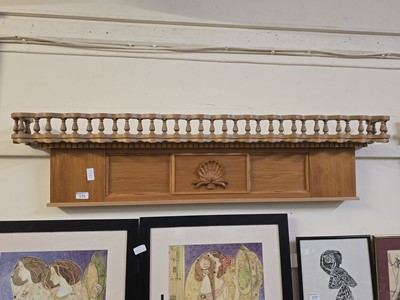 Lot 175 - A galleried waxed pine wall shelf with shell...
