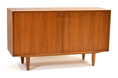 Lot 22 - A 1960's teak two-door cabinet with a beech...