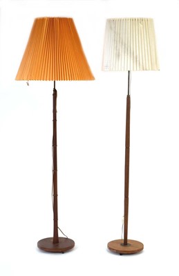 Lot 37 - Two 1960's Danish turned teak standard lamps...